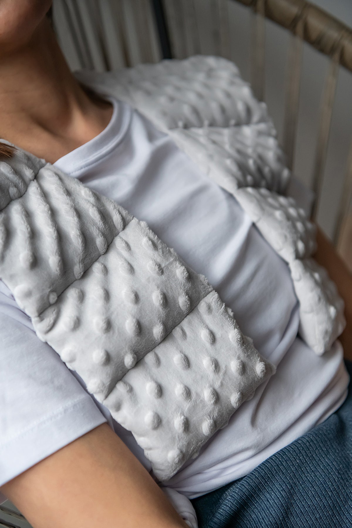 woman wearing long minky weighted collar  in light grey shade made by sensory owl 