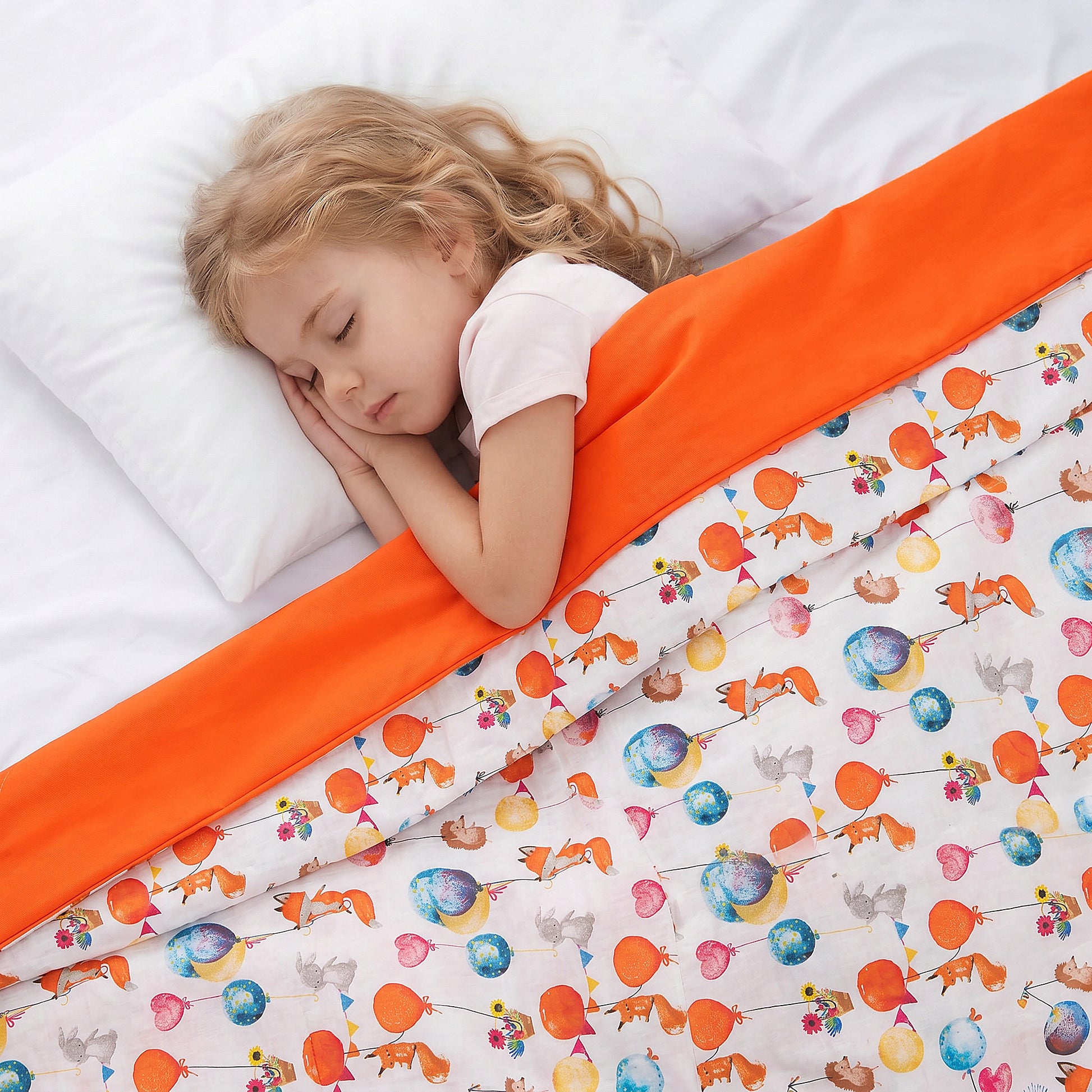a girl sleeping under the weighted blanket with the forest party cotton print
