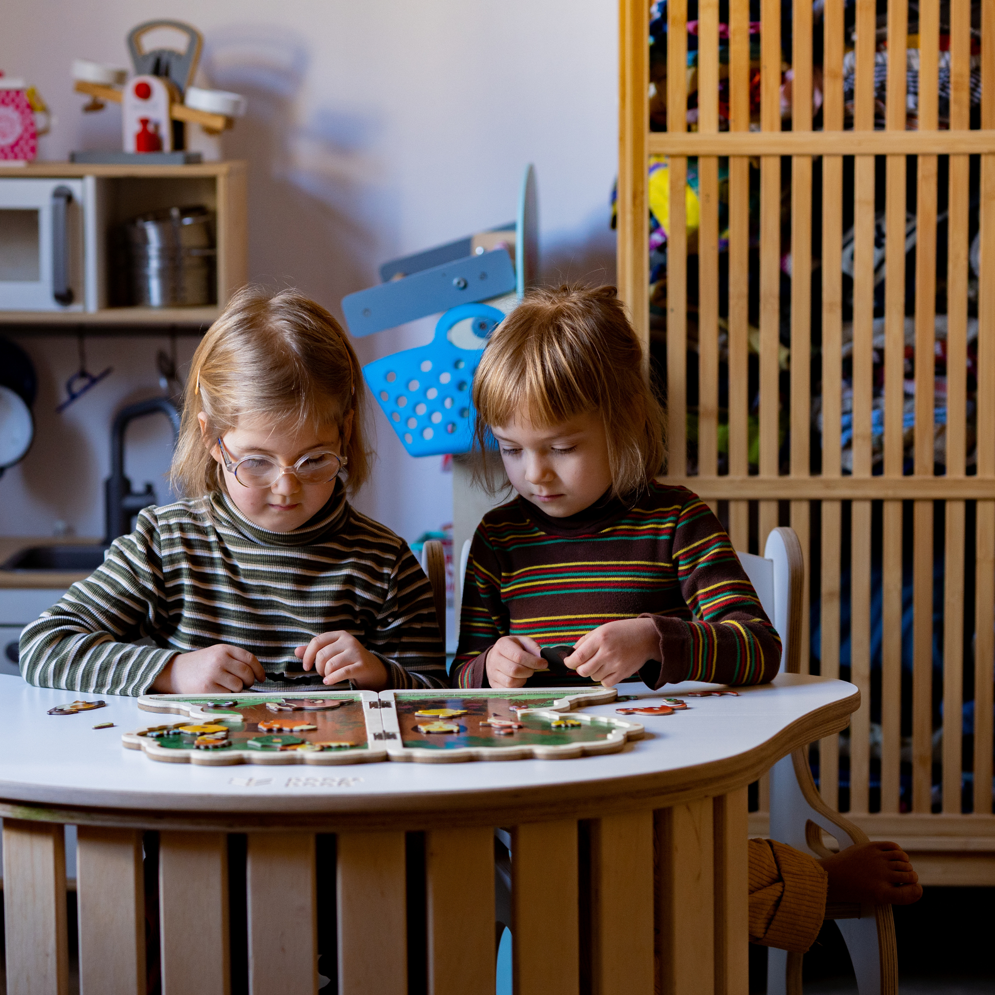 GIRLS PLAYING AT TABLETOP FOR ROCKER- GOOD WOOD