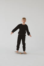 Cargar imagen en el visor de la galería, A BOY BALANCING ON THE GREY BALANCE BOARD / TRICK BOARD FOR KIDS- GOOD WOOD
